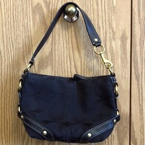 Coach black purse with gold accents.
